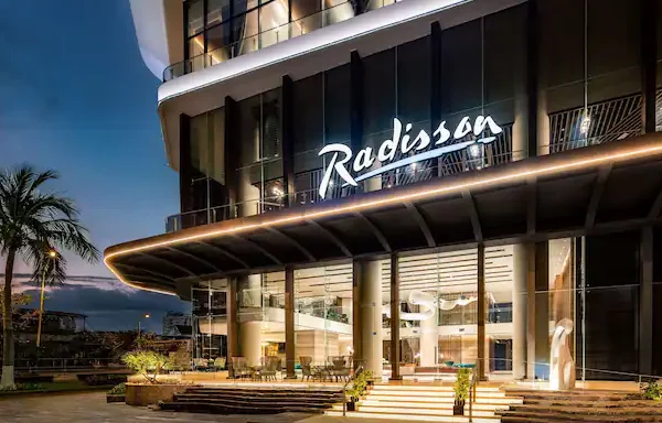 A modern Radisson hotel exterior at sunset-new hotel openings and expansion plans in South Africa.
