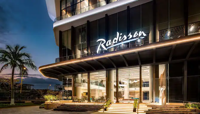 A modern Radisson hotel exterior at sunset-new hotel openings and expansion plans in South Africa.